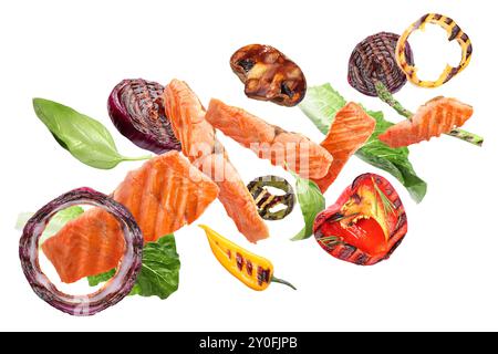 Delicious grilled salmon and vegetables flying on white background Stock Photo