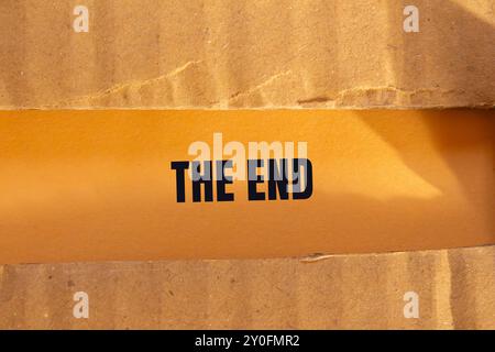 The end message written on ripped torn cardboard paper with orange ...