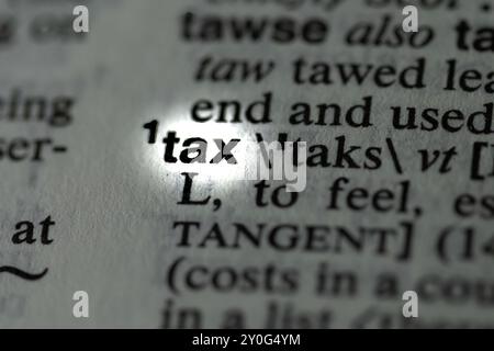 Close-Up of Dictionary Page with the Word 'Tax' – Exploring Taxation and Its Role in Finance Stock Photo