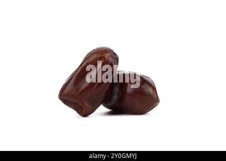Two dried tropical dates isolated on white background. Copy space. Stock Photo