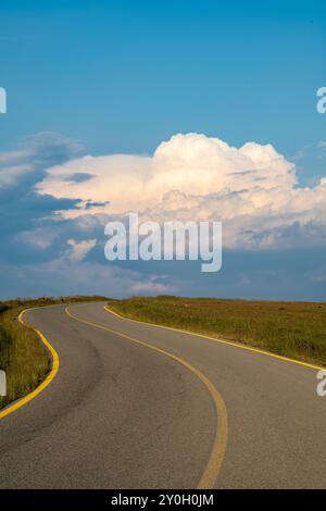 Road leading to beautiful clouds and blue skies. Stock Photo