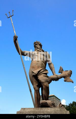 Statue of Neptune (Poseidon) god of the sea with trident, against blue sky,  Bristol city centre. Taken September 2024. Summer Stock Photo