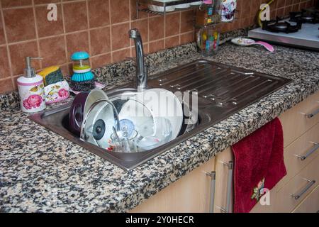 Close-up view of dirty dishes in the sink in a domestic kitchen Stock Photo