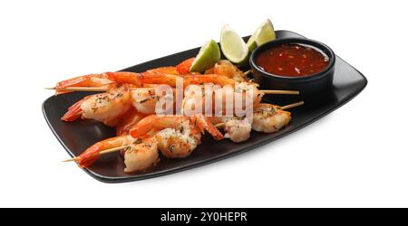 Delicious grilled shrimp skewers with sauce and lime isolated on white Stock Photo