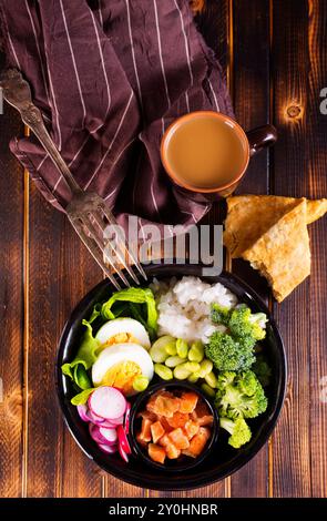 Rice with red fish, green beans and broccoli in a black plate. Diet. Top view. Free space for text. Stock Photo