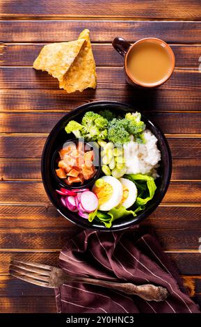 Rice with red fish, green beans and broccoli in a black plate. Diet. Top view. Free space for text. Stock Photo