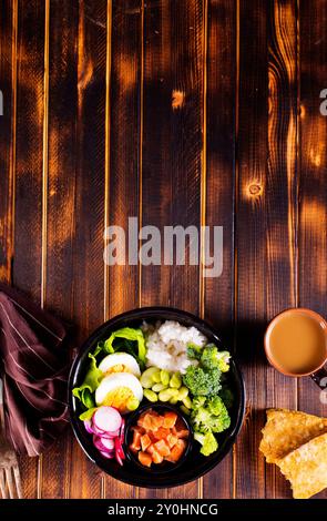 Rice with red fish, green beans and broccoli in a black plate. Diet. Top view. Free space for text. Stock Photo