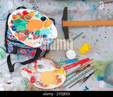 Artist colour mixing palette with various tools used including brushes and paints. Stock Photo