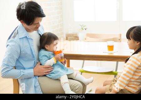 Baby and family drinking tea Stock Photo