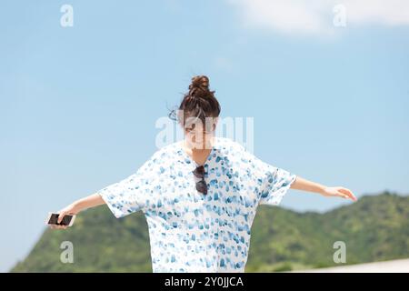 Woman walking with arms outstretched Stock Photo