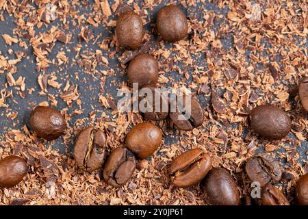 Roasted coffee beans lie together with chocolate crumbled into small pieces, fragrant coffee together with chocolate crumbs Stock Photo