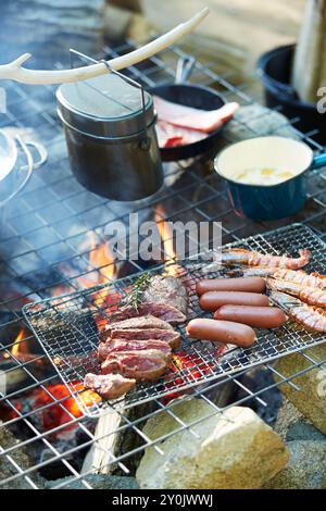 Cooking in a campsite kamado Stock Photo