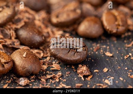 Roasted coffee beans lie together with chocolate crumbled into small pieces, fragrant coffee together with chocolate crumbs Stock Photo