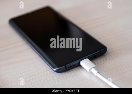 port usb type-C connection to the device, new fast USB Type-C port on mobile phone and cable Stock Photo