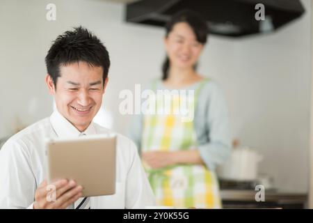 Husband watching a tablet Stock Photo
