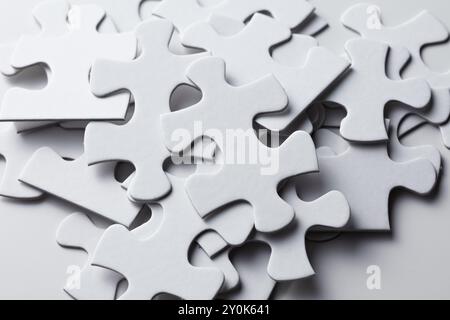 Scattered white pieces of  jigsaw puzzle Stock Photo