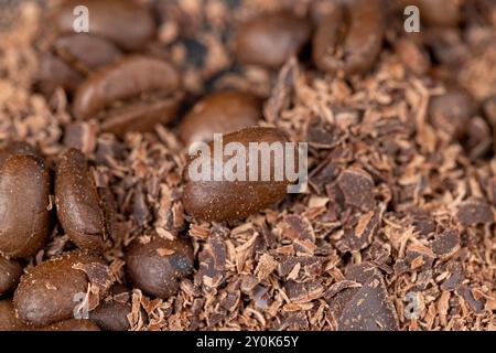 Roasted coffee beans lie together with chocolate crumbled into small pieces, fragrant coffee together with chocolate crumbs Stock Photo