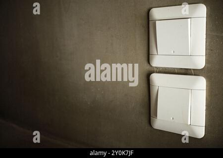 Tabanan, Bali, Indonesia - August 27, 2024: A white light switch by Schneider Electric with a concrete wall background Stock Photo