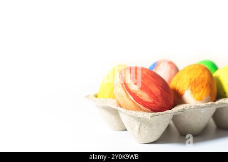 Colorful easter eggs in egg carton isolated on white background. copy space Stock Photo