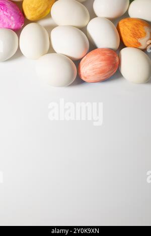 Easter eggs and pastel colored eggs on a white background with space for your text. Stock Photo