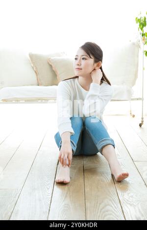 Refreshing woman relaxing in a room Stock Photo