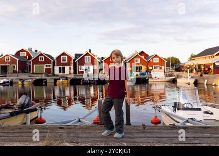 Family, visiting small village Lorudden in Sweden, summertime. Scandinavian coastal village Stock Photo