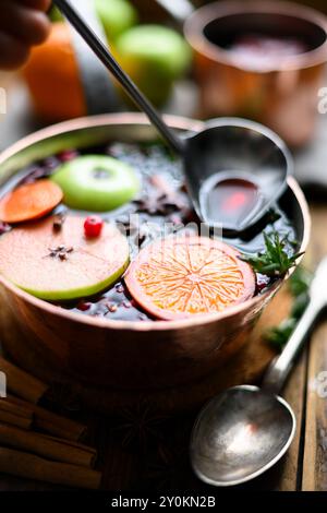 Mulled wine in copper pot with scoop and spoon. Food photography Stock Photo