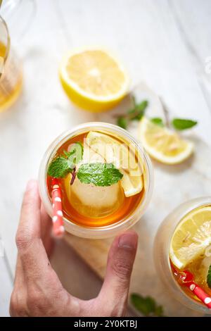 Homemade iced peach tea with lemon, selective focus Stock Photo