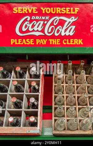 Drempt, The Netherlands - May 25, 2023:  Vintage wooden crates with Coca-Cola bottles on a stand in Drempt, The Netherlands Stock Photo