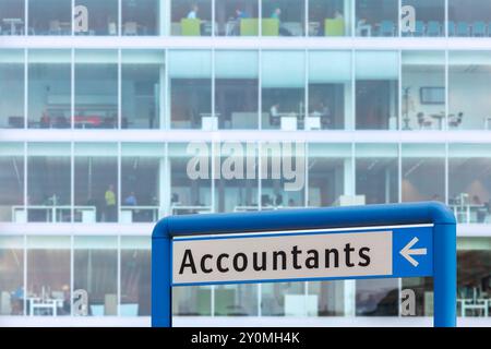Accountants information sign in front of a blurred office with working people Stock Photo