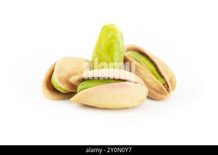 Peeled roasted pistachios in burlap sack isolated on white background, healthy nut Stock Photo