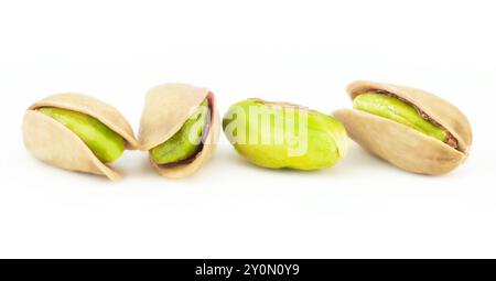 Peeled roasted pistachios in burlap sack isolated on white background, healthy nut Stock Photo