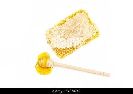 Piece of honeycomb, organic fresh liquid honey with dipper isolated on white background, healthy food Stock Photo