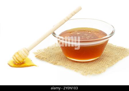Piece of honeycomb, organic fresh liquid honey with dipper isolated on white background, healthy food Stock Photo