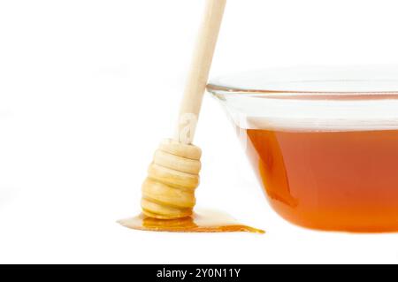 Piece of honeycomb, organic fresh liquid honey with dipper isolated on white background, healthy food Stock Photo
