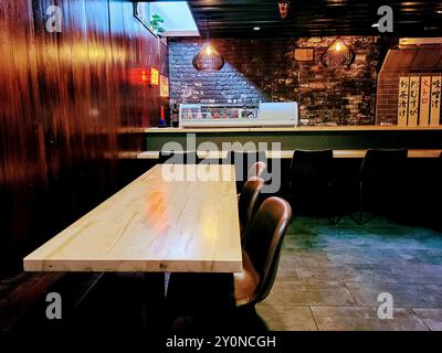 Modern Sushi Bar Interior with Communal Dining Table at Eye-Level Perspective Stock Photo