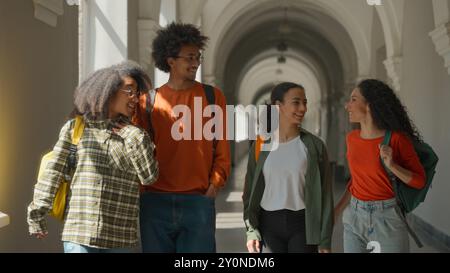 Group of multiracial students four diversity friends African American Hispanic Latina classmates buddies man male guy women female girls smiling happy Stock Photo
