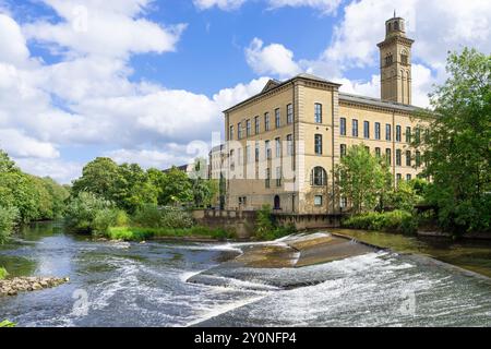 Saltaire Bradford - Salts Mill New Mill and the River Aire weir Saltaire Village Bradford West Yorkshire England UK GB Europe Stock Photo