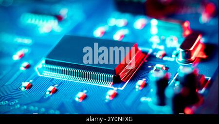 Electronic printed circuit board PCB close up holding integrated circuit (IC) also known as a microchip or computer chip. Stock Photo