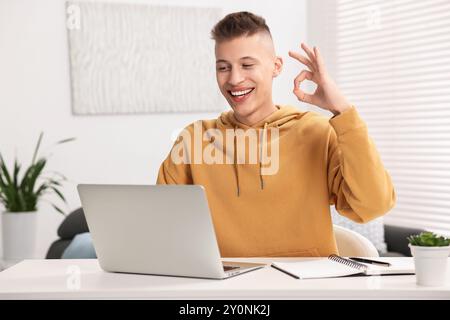 Young man using sign language during video call indoors Stock Photo