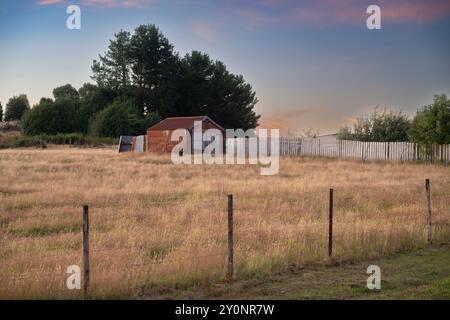 Fenced field on the exterior of the town of Waratah, which was constructed to support a tin mine at Mount Bischoff, Tasmania, Australia Stock Photo