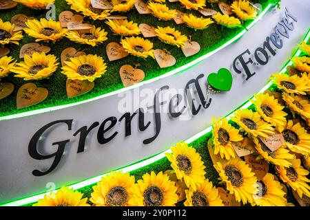 London, UK. 3rd Sep, 2024. Life goes on around the memorial wall (which includes a winged heart made up of messages on sunflowers), as the tower looms above, on the day before the report on the Grenfell Tower disaster is released. Those involved remain upset and frustrated that no-one has been called to account for the tragedy and hope this may change after tomorrow. Credit: Guy Bell/Ģ����ý Live News Stock Photo