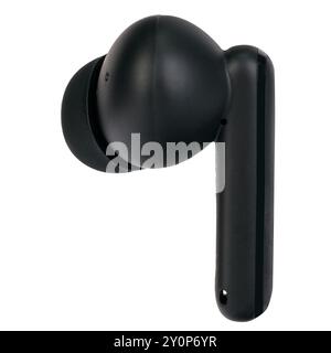 Close-up side view of a single black wireless earbud on a white background. Stock Photo