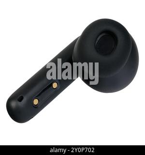 Close-up of a black wireless earbud placed against a white background. Stock Photo