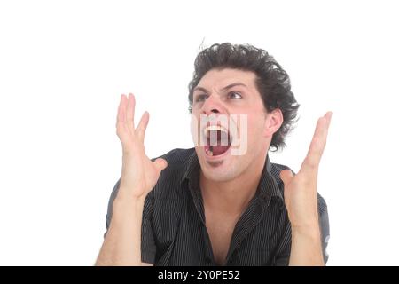 young angry  man with shocked facial expression shouting Stock Photo