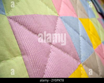 Fragment of a patchwork quilt made of multi-colored fabric rectangles Stock Photo