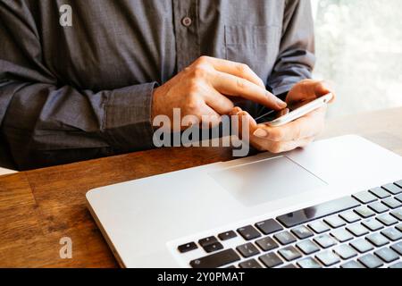 Businessman using smartphone and laptop Stock Photo