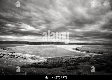 Sunset over Wheat fields with dramatic black and white sky and foreground, in Eastern Oregon. USA. Stock Photo