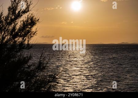 Beautiful sunset over small tourist town of Primosten, Croatia Stock Photo