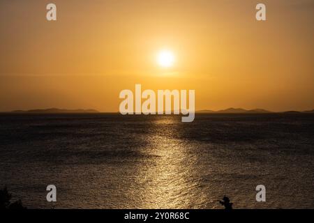 Beautiful sunset over small tourist town of Primosten, Croatia Stock Photo